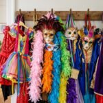 Bunte Verkleidungen und Masken hängen an einer Garderobe